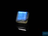 a close up of a square blue stone on a black surface