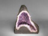 an amethorate with purple and white crystals on a gray surface