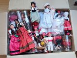 a cardboard box with a bunch of dolls in it