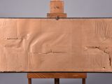an easel with a piece of cardboard sitting on top of it