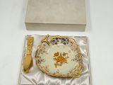 a plate and a spoon in a box on a table