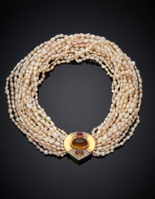 a multi strand pearl necklace with a gold clasp