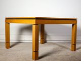 a wooden table that is sitting in the middle of a room