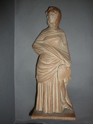 a statue of a woman with a shaw around her neck