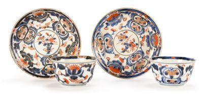 three cups and a saucer sitting on a white surface