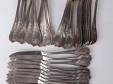 a lot of spoons and forks on the table