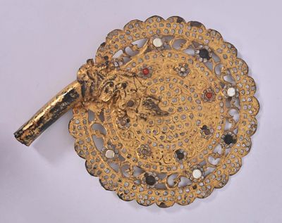 gold plated brooch with a lion head on it and a red stone in the center