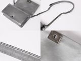 grey leather purse with chain strap on white background