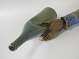 a blue and green bottle with a hand on it