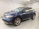 a picture of a blue nissan suv in a garage