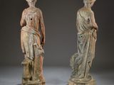 two statues of a woman and a man standing next to each other