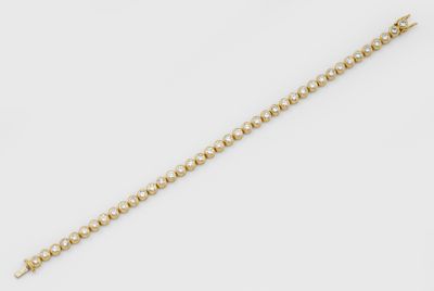 a gold bracelet with a ball chain and a clasp