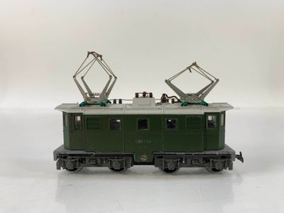 a green train car that is sitting on a white surface