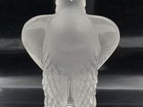 a clear glass vase with a bird on it