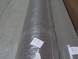 several rolls of fabric are stacked on top of each other in a warehouse