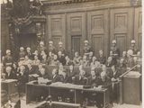 a black and white photo of a large group of people in a courtroom