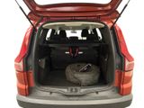 the back of a red car with the trunk open and a tire in the trunk