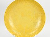 a yellow plate with a floral design on it
