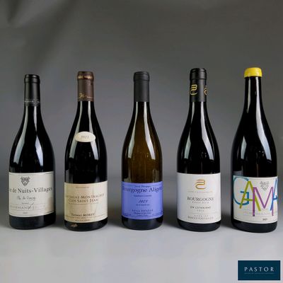 several bottles of wine are lined up in a row on a table