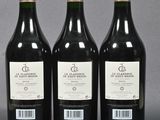 three bottles of wine sitting on top of a table next to each other