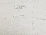 a close up of a clock on a white wall
