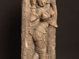 a stone statue of a man holding a baby in his arms