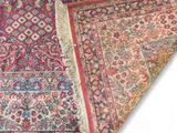 a close up of a red and blue rug on a white background