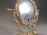 a mirror that is sitting on a stand on a table