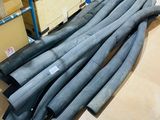 a lot of pipes sitting on the floor in a warehouse