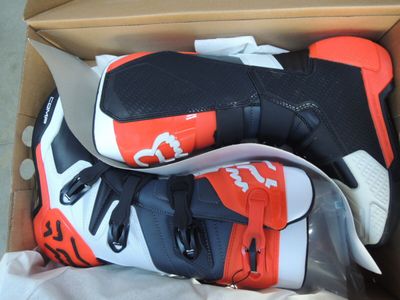 two pairs of shoes in a box on the floor