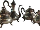 three pieces of silver tea and coffee set on a white background