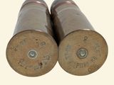 two bullet shells sitting next to each other on a white surface