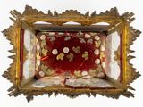 a picture of a red and gold box with gold hearts on it