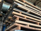 a large stack of pallets stacked on top of each other in a warehouse