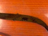 the back of a violin with a label on the back of it