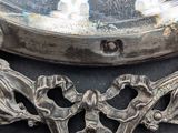 a close up of a mirror with a clock in the background