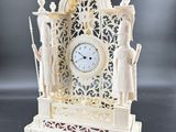 a white clock that is sitting on a table