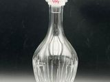a clear glass bottle with a glass stopper on it