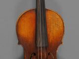 an old violin with a bow on a gray background