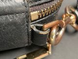 a close up of a purse with a chain attached to it