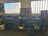 a workbench in a garage with a lot of tools on it