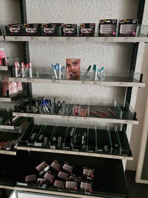 a lot of makeup products on the shelves in the room