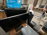 two televisions and a printer sitting on the floor