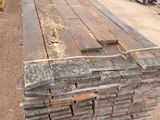 a pile of wooden planks stacked on top of each other