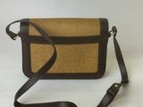an image of a brown and black purse on a white background