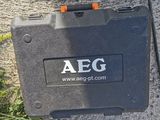 the aeg box is sitting on the ground next to the grass