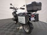 a motorcycle parked in a room with a black and white checkered floor