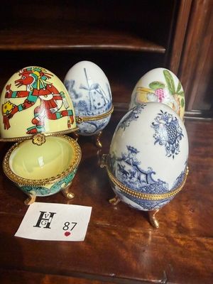 three eggs are sitting on a table with a price tag in front of them