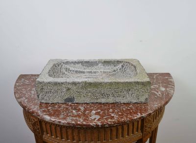 a stone sink sitting on top of a table