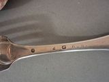 a spoon and a spoon rest on a table
